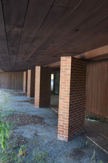Parking spaces separated by brick columns